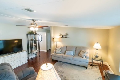 Nestled within the welcoming embrace of Whispering Pines in on Lily Lake Golf and RV Resort in Florida - for sale on GolfHomes.com, golf home, golf lot