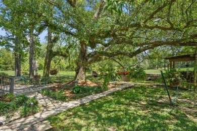 Lovely raised Acadian cottage on an oversized lot fronting the on Covington Country Club in Louisiana - for sale on GolfHomes.com, golf home, golf lot