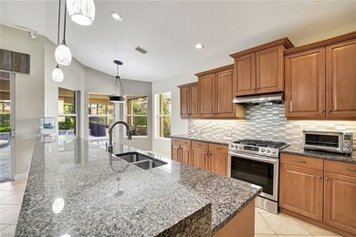 Shaded by the expansive canopy of a mature oak, the backyard is on Villages of Country Creek Golf Course in Florida - for sale on GolfHomes.com, golf home, golf lot