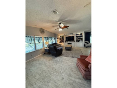 Indulge in expansive living within this magnificent double-wide on Hamptons Golf Club in Florida - for sale on GolfHomes.com, golf home, golf lot