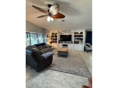 Indulge in expansive living within this magnificent double-wide on Hamptons Golf Club in Florida - for sale on GolfHomes.com, golf home, golf lot