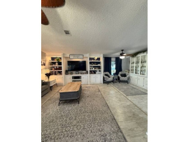 Indulge in expansive living within this magnificent double-wide on Hamptons Golf Club in Florida - for sale on GolfHomes.com, golf home, golf lot
