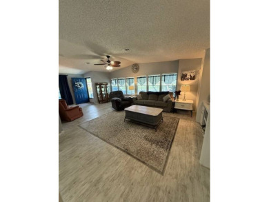 Indulge in expansive living within this magnificent double-wide on Hamptons Golf Club in Florida - for sale on GolfHomes.com, golf home, golf lot