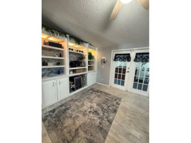Indulge in expansive living within this magnificent double-wide on Hamptons Golf Club in Florida - for sale on GolfHomes.com, golf home, golf lot