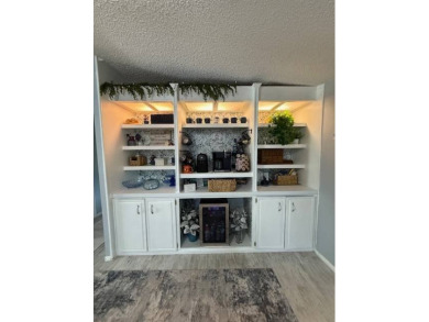 Indulge in expansive living within this magnificent double-wide on Hamptons Golf Club in Florida - for sale on GolfHomes.com, golf home, golf lot