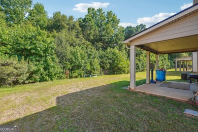 The spacious home features 5 bedrooms, 3 full baths, and a 2-car on Canongate At Heron Bay in Georgia - for sale on GolfHomes.com, golf home, golf lot