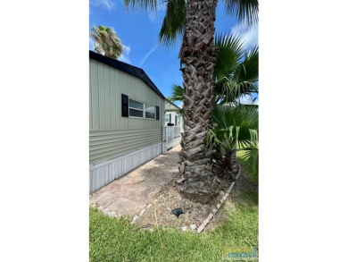 Cute and nicely updated park model featuring large full length on Long Island Golf Course in Texas - for sale on GolfHomes.com, golf home, golf lot