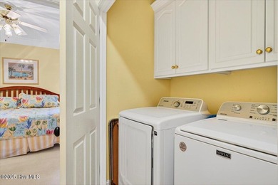 Waterfront overlooking a tranquil pond, this exquisitely on Members Club At St. James Plantation in North Carolina - for sale on GolfHomes.com, golf home, golf lot