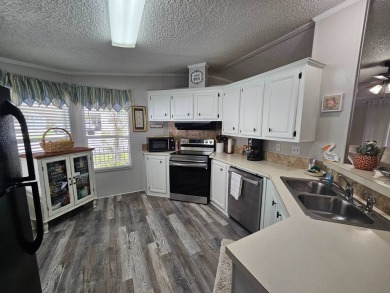 This immaculate 2-bedroom, 2-bath home has vinyl plank flooring on Big Cypress Golf and Country Club in Florida - for sale on GolfHomes.com, golf home, golf lot