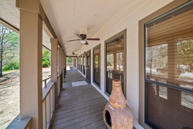 This property at Holly Lake Ranch offers a large covered front on Holly Lake Ranch Golf Club in Texas - for sale on GolfHomes.com, golf home, golf lot