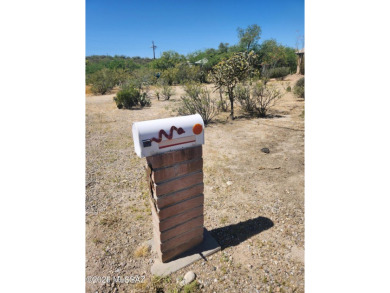 Surround yourself with the serenity of nature in this on Arizona National Golf Club in Arizona - for sale on GolfHomes.com, golf home, golf lot