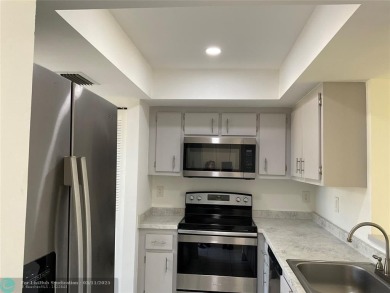 Stylish and serene 2-bedroom, 2-bathroom condo with breathtaking on Oriole Golf and Tennis Club in Florida - for sale on GolfHomes.com, golf home, golf lot