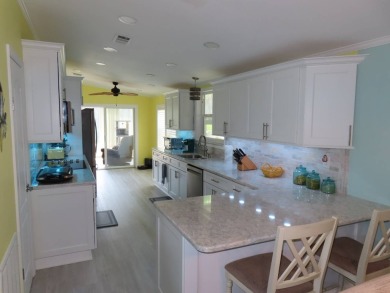 Watch the sunrise or just relax in your glass enclosed 4 season on Crane Lakes Golf and Country Club in Florida - for sale on GolfHomes.com, golf home, golf lot