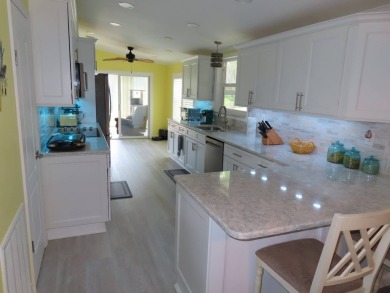Watch the sunrise or just relax in your glass enclosed 4 season on Crane Lakes Golf and Country Club in Florida - for sale on GolfHomes.com, golf home, golf lot