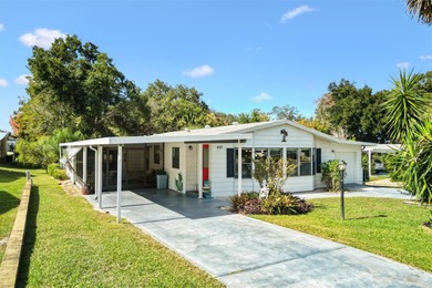 2/2 Manufactured Home with Dual Screened Lanais, Carport and on El Diablo Executive Golf Course in Florida - for sale on GolfHomes.com, golf home, golf lot