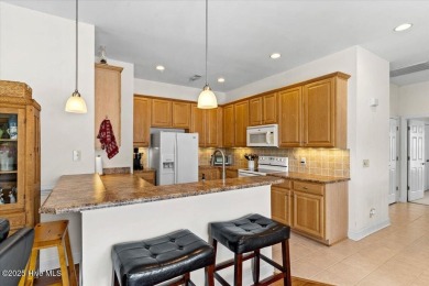 This inviting second-floor condo in the gated community of on Brunswick Plantation and Golf Resorts in North Carolina - for sale on GolfHomes.com, golf home, golf lot