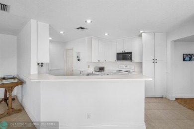 With serene views of the water and golf course, a 2021 roof, and on The Boca Country Club in Florida - for sale on GolfHomes.com, golf home, golf lot