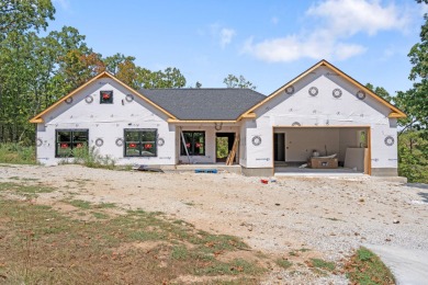 Tucked inside a gated golf community, this newly constructed on Ledgestone Country Club and Golf Course in Missouri - for sale on GolfHomes.com, golf home, golf lot