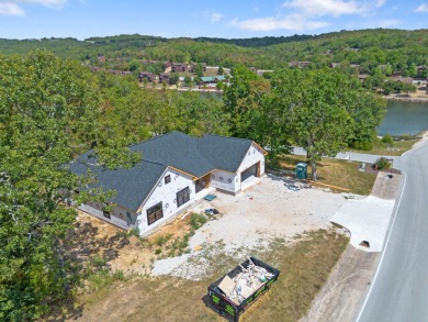 Tucked inside a gated golf community, this newly constructed on Ledgestone Country Club and Golf Course in Missouri - for sale on GolfHomes.com, golf home, golf lot