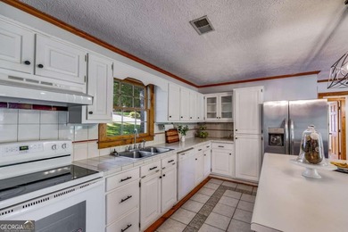 Wake up to sparkling lake views every day in this beautiful 3 on Fairfield Plantation Golf and Country Club in Georgia - for sale on GolfHomes.com, golf home, golf lot