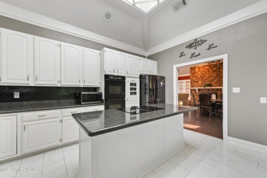 Enjoy timeless elegance and custom craftsmanship in this on Diamondhead Country Club in Mississippi - for sale on GolfHomes.com, golf home, golf lot