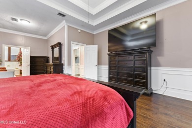 Enjoy timeless elegance and custom craftsmanship in this on Diamondhead Country Club in Mississippi - for sale on GolfHomes.com, golf home, golf lot