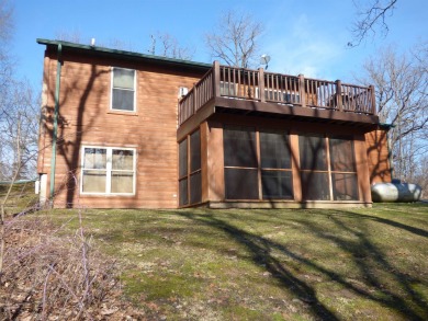 Discover the charm of this four-bedroom, cabin-style home in on Apple Canyon Lake Golf Course in Illinois - for sale on GolfHomes.com, golf home, golf lot