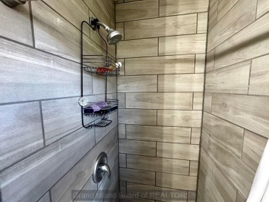This charming home sits on a large lot with mature trees on the on Indianhead Golf Club in Nebraska - for sale on GolfHomes.com, golf home, golf lot