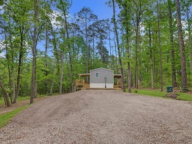 Nestled among the pines, this charming 2-bedroom, 2-bath turnkey on Rayburn Country Club in Texas - for sale on GolfHomes.com, golf home, golf lot