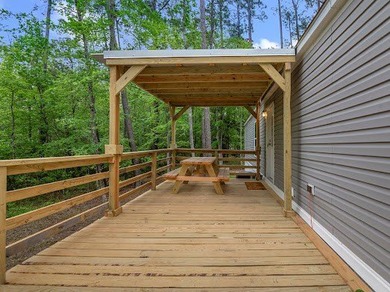 Nestled among the pines, this charming 2-bedroom, 2-bath turnkey on Rayburn Country Club in Texas - for sale on GolfHomes.com, golf home, golf lot