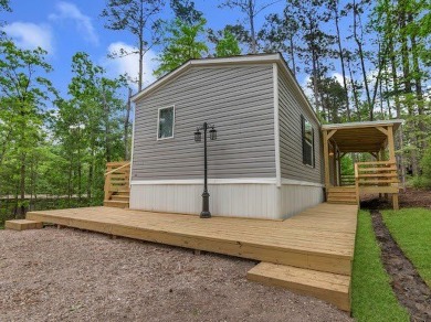 Nestled among the pines, this charming 2-bedroom, 2-bath turnkey on Rayburn Country Club in Texas - for sale on GolfHomes.com, golf home, golf lot