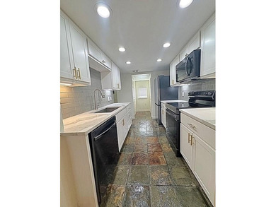 This modern updated condo offers quartz counters, cement tile on Las Colinas Country Club in Texas - for sale on GolfHomes.com, golf home, golf lot