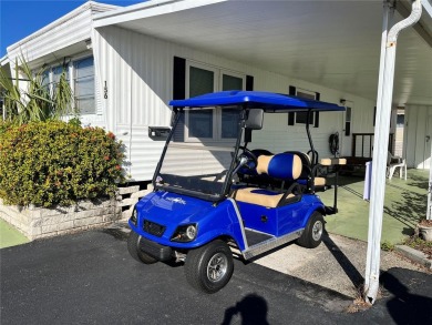 This 2 bedroom 1 1/2 bath home has a screened in porch and on Mangrove Bay Golf Course in Florida - for sale on GolfHomes.com, golf home, golf lot
