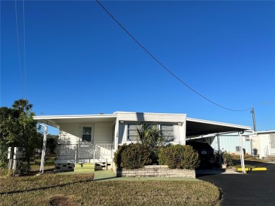 This 2 bedroom 1 1/2 bath home has a screened in porch and on Mangrove Bay Golf Course in Florida - for sale on GolfHomes.com, golf home, golf lot