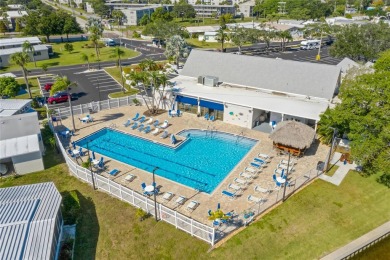 This 2 bedroom 1 1/2 bath home has a screened in porch and on Mangrove Bay Golf Course in Florida - for sale on GolfHomes.com, golf home, golf lot