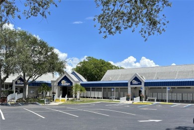 This 2 bedroom 1 1/2 bath home has a screened in porch and on Mangrove Bay Golf Course in Florida - for sale on GolfHomes.com, golf home, golf lot