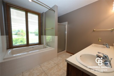 Enjoy peaceful evenings on your covered back deck overlooking on The Golf Club At Southwind in Kansas - for sale on GolfHomes.com, golf home, golf lot