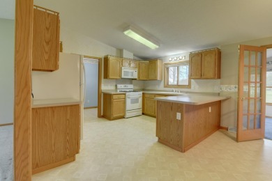 Tee off to easy living perfectly situated on beautiful Country on Country Greens Golf Course in Iowa - for sale on GolfHomes.com, golf home, golf lot