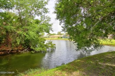 With a private, tranquil water and golf course view, this bright on Spruce Creek Golf Club in Florida - for sale on GolfHomes.com, golf home, golf lot