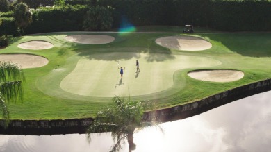 Spectacular lake and lush double fairway views from this 1st on Pine Tree Golf Club in Florida - for sale on GolfHomes.com, golf home, golf lot