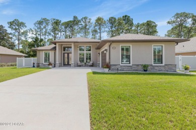 Welcome to 13 Elder Drive, Palm Coast - A Modern Masterpiece in on The Grand Club Cypress Course in Florida - for sale on GolfHomes.com, golf home, golf lot