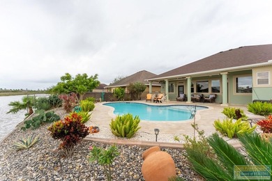 Experience refined lakefront living in this beautifully on South Padre Island Golf Club in Texas - for sale on GolfHomes.com, golf home, golf lot