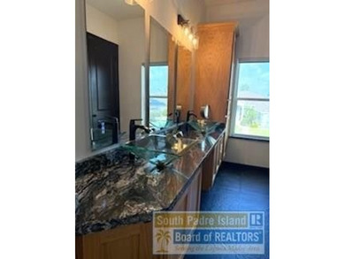 Luxury living in paradise! Located on prestigious Laguna Madre on South Padre Island Golf Club in Texas - for sale on GolfHomes.com, golf home, golf lot