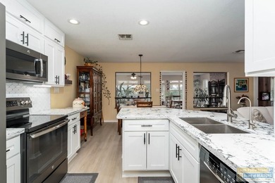 Inviting lakefront home with golf course views, set along a on South Padre Island Golf Club in Texas - for sale on GolfHomes.com, golf home, golf lot