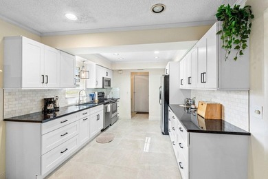 Discover the ultimate blend of elegance and effortless living in on Quail Ridge Golf Course and Country Club in Florida - for sale on GolfHomes.com, golf home, golf lot