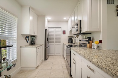 Open the door to this beautifully renovated 1/1.5 bath condo and on Poinciana Golf Club in Florida - for sale on GolfHomes.com, golf home, golf lot