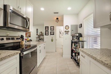 Open the door to this beautifully renovated 1/1.5 bath condo and on Poinciana Golf Club in Florida - for sale on GolfHomes.com, golf home, golf lot