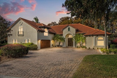 Set along approximately 82 feet of shimmering Lake Dora on Deer Island Country Club in Florida - for sale on GolfHomes.com, golf home, golf lot