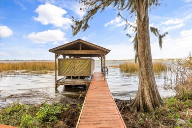 Set along approximately 82 feet of shimmering Lake Dora on Deer Island Country Club in Florida - for sale on GolfHomes.com, golf home, golf lot