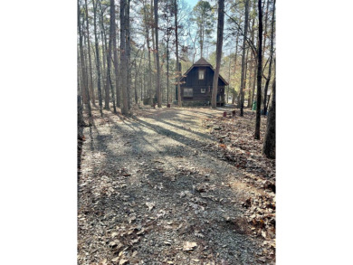 Adorable Cabin in the woods with red line behind the house and on Tannenbaum Golf Club in Arkansas - for sale on GolfHomes.com, golf home, golf lot